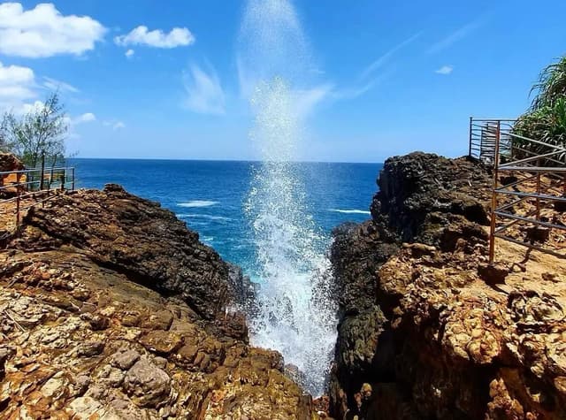 Hummanaya Blowhole spraying water high above the rocky coast