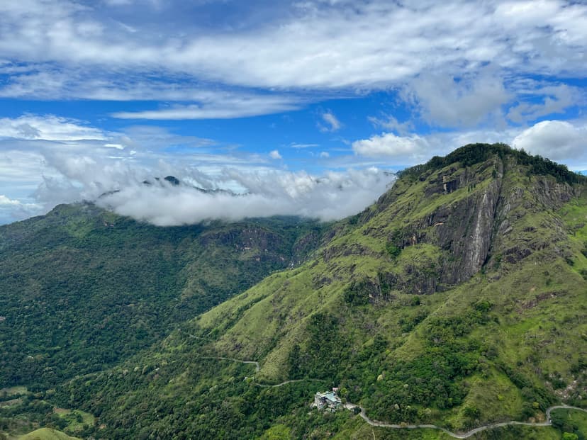 Hikers on Little Adams Peak summit with panoramic views of Ella Gap and surrounding tea plantations