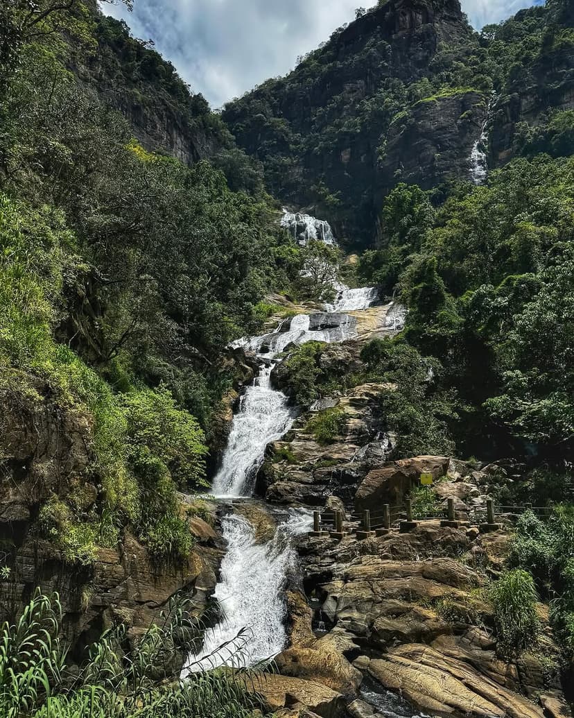 Majestic Ravana Falls cascading down rocky cliffs near Ella with pool for swimming