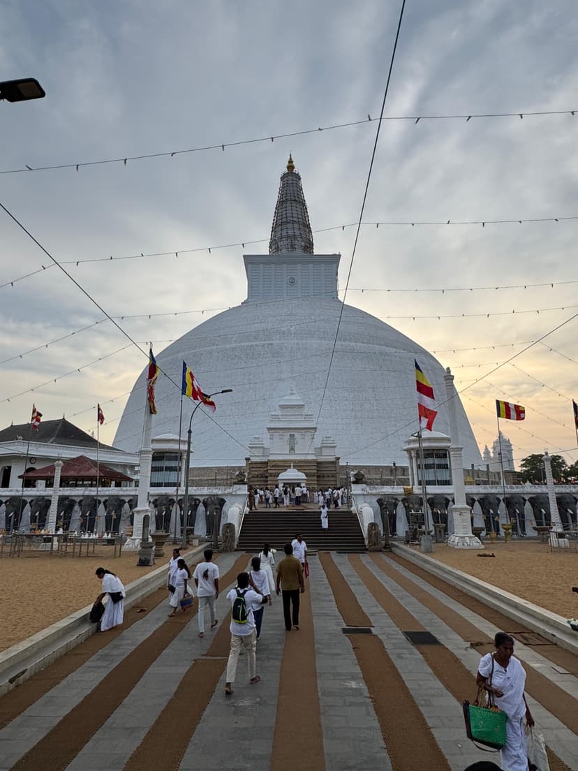 Magnificent white Ruwanwelisaya dagoba with its distinctive dome shape and surrounding elephant wall