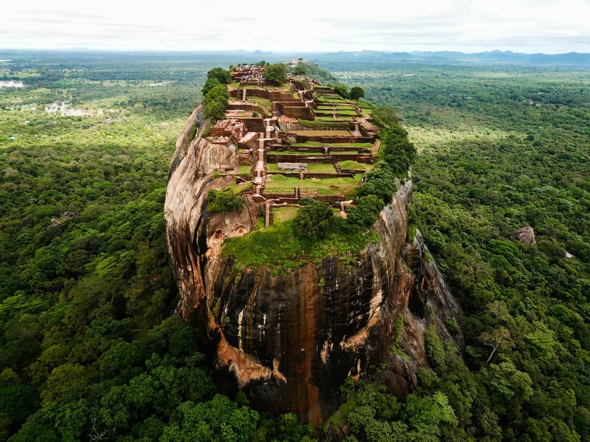 Panoramic view from Sigiriya summit showing vast green landscape and ancient palace ruins