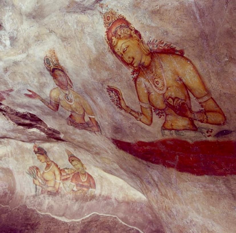 Close-up of Sigiriya frescoes showing detailed ancient paintings of women with jewelry and flowers