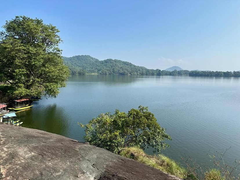 Sorabora Wewa ancient reservoir showing calm waters surrounded by green hills and wildlife