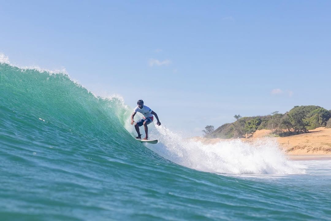 Surfer riding a wave at Arugam Bay Main Point