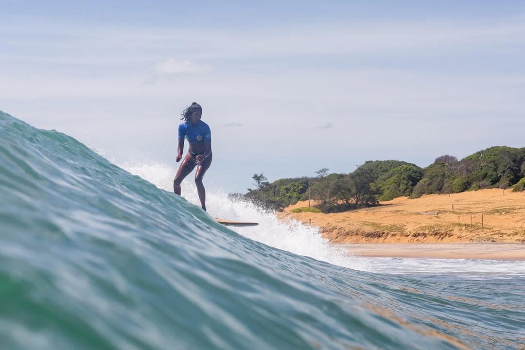 Surfer riding a wave at Arugam Bay Main Point