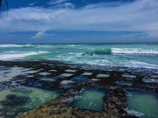 Thalpe Beach coral wells and golden sand with turquoise water