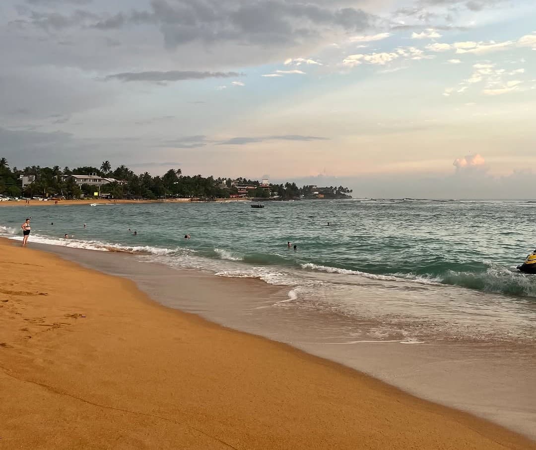 Aerial view of Unawatuna Beach with its crescent shape and turquoise waters
