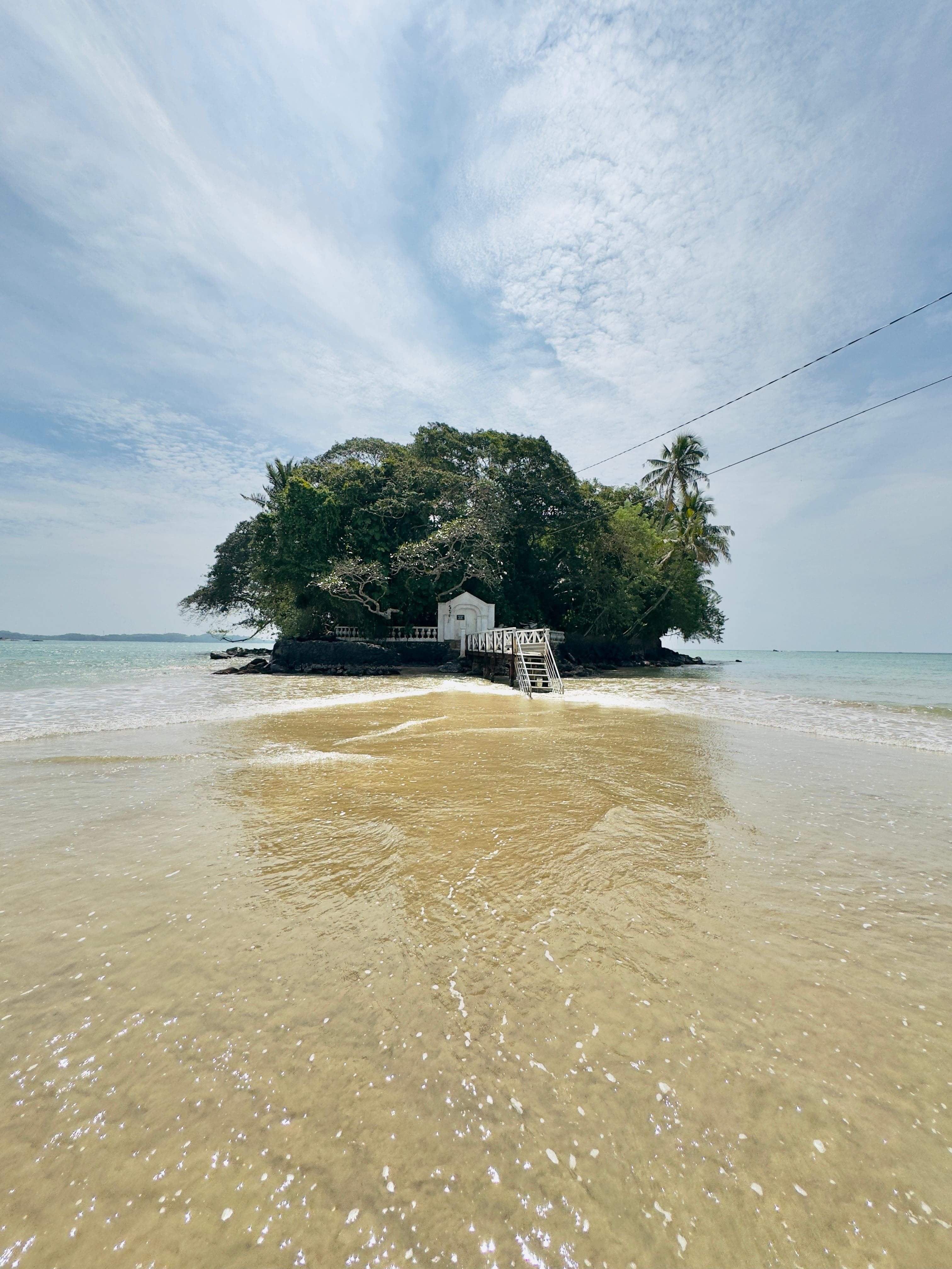 Sandy causeway connecting Snake Island to mainland