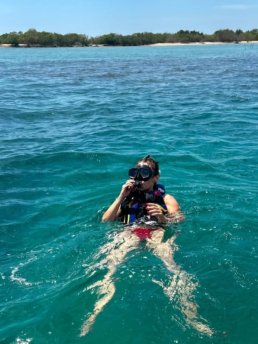 Snorkelers exploring colorful coral reefs in Pasikuda with tropical fish and clear blue water